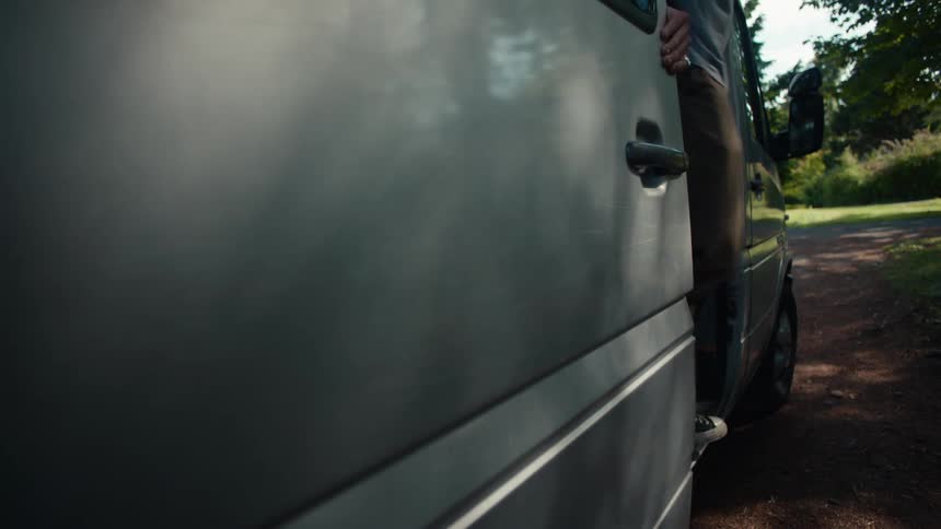 Person getting out of a parked minivan