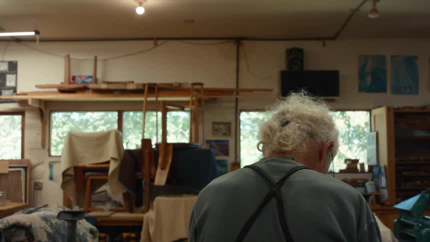 Elderly carpenter working in an indoor space