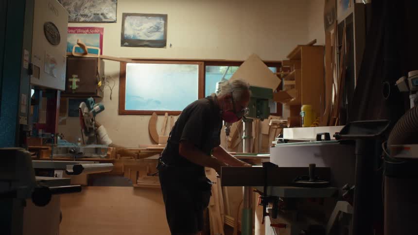 Elderly carpenter working in an indoor space