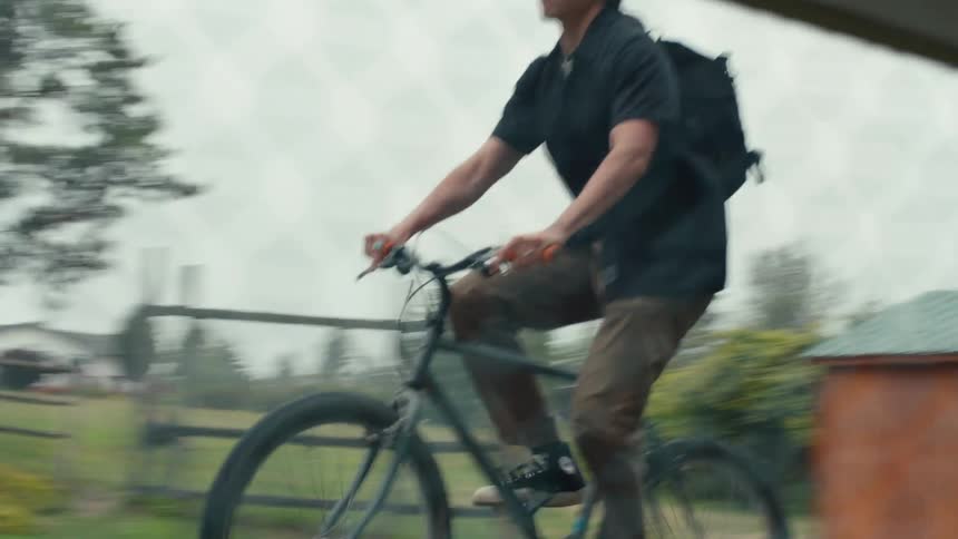 Young man riding a bicycle during a cloudy day