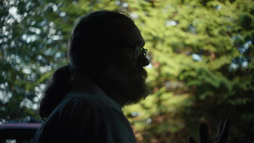 A man is talking in the shade
