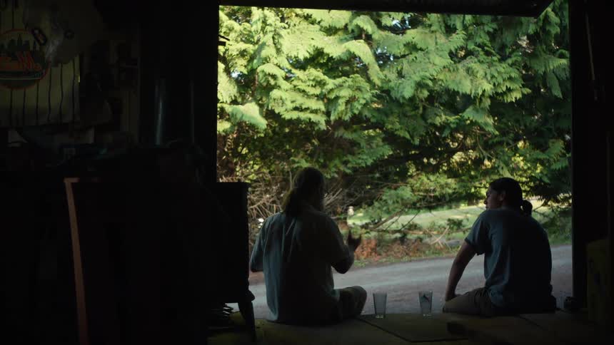 Two men sitting talking to each other