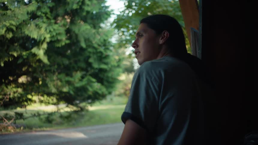 Young man sitting talking and shaking his head