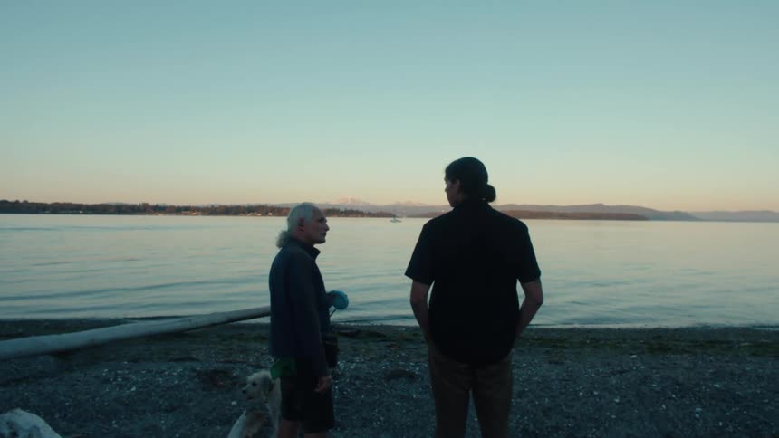 Two men are talking by the lake
