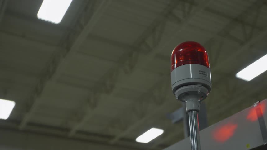 A red alarm light rotates and shines