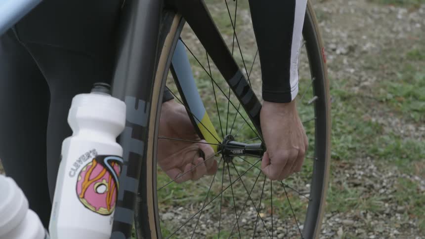 Person fixes someone on the tire of their bike