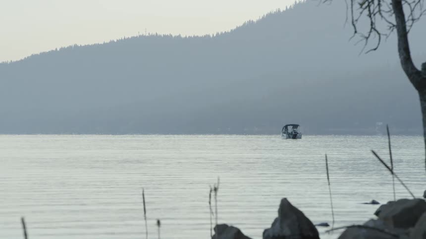A boat floats on glistening water