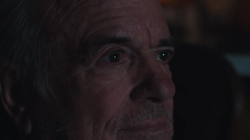 Elderly man sitting watching