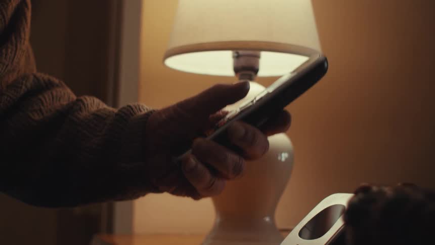 A man smiles while talking on the phone