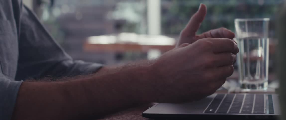 A man is talking on his laptop