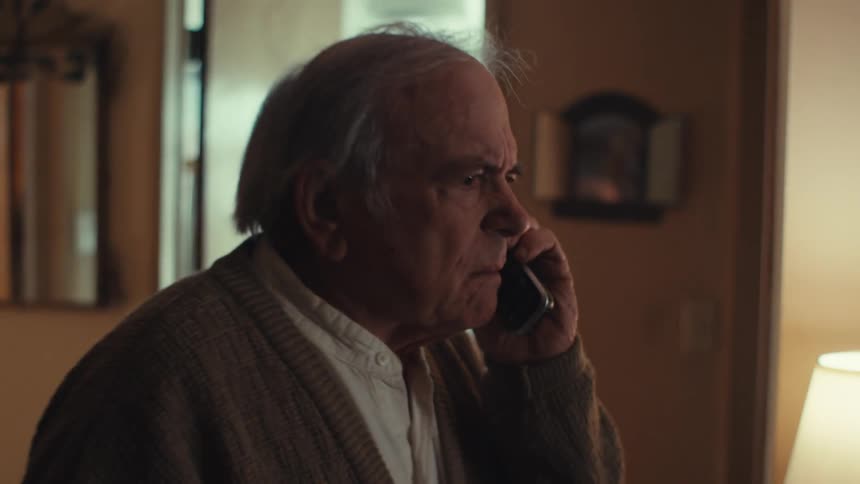 Elderly man talking on the phone angrily