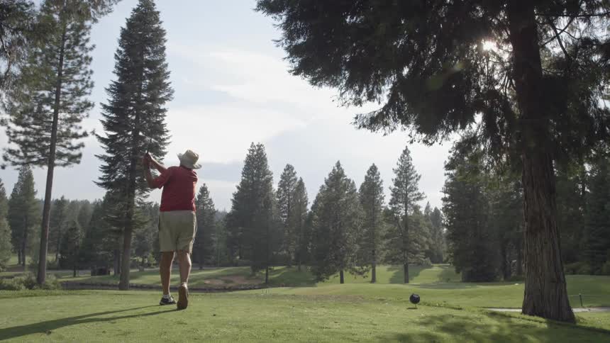 A man drives a golf ball