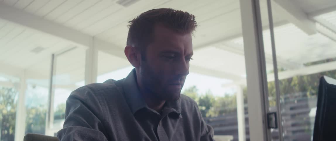 Focused man typing on laptop