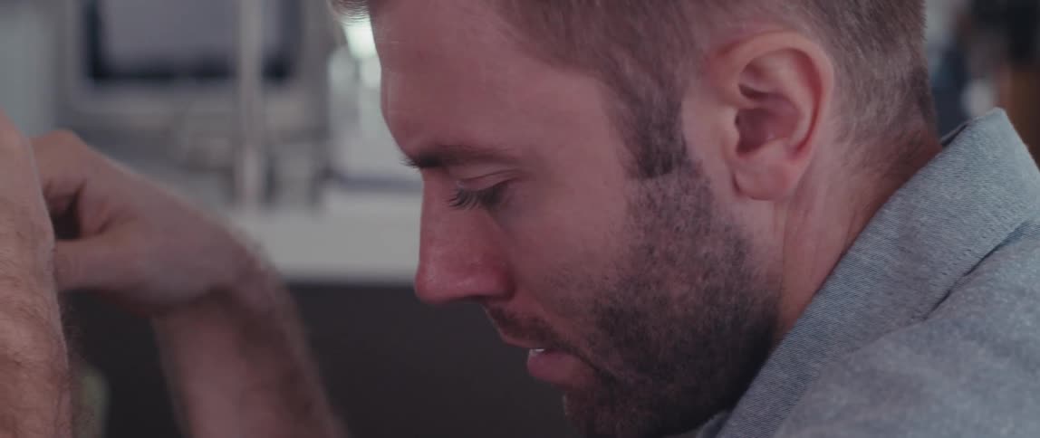 Side view of a bearded man talking