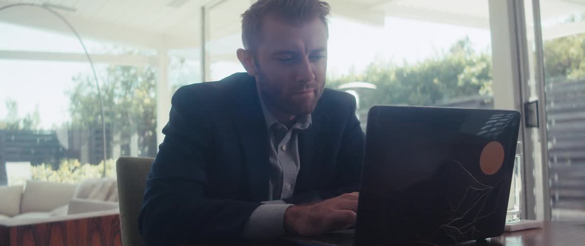 A man is using his laptop