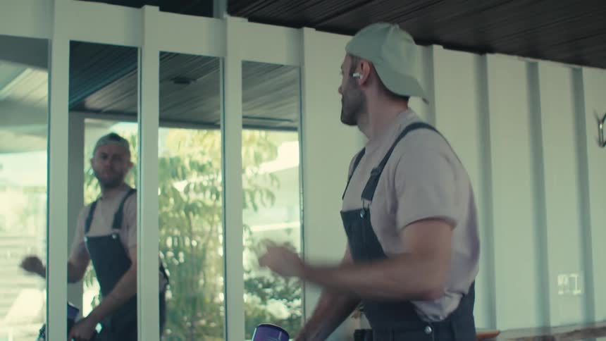Man enjoying music while using a vacuum cleaner