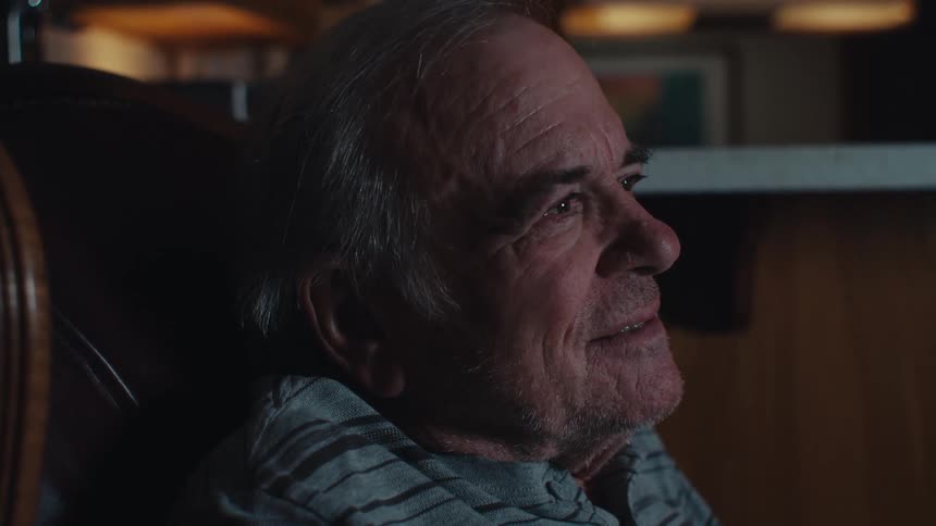 A man is having fun watching tv