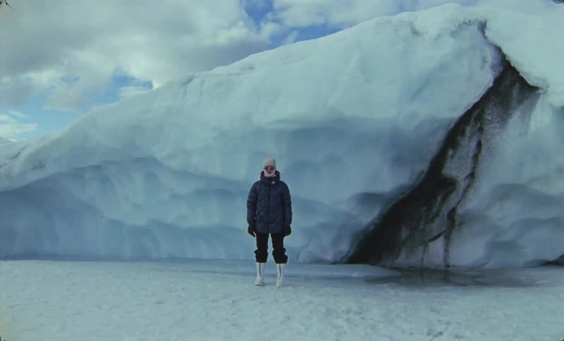 Person in jacket and hat walking on glaciers