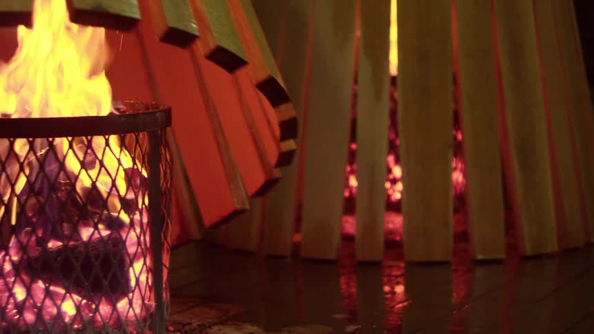 Decoration with a wooden arch on top of a bonfire with embers