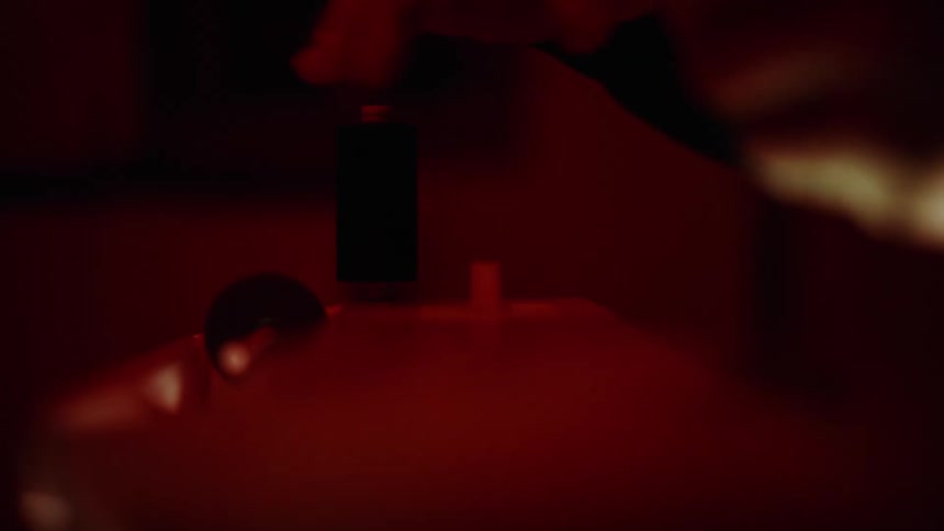 Person places a spool of thread onto a sewing machine