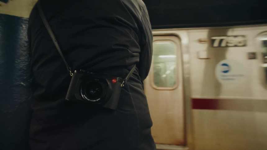 Camera on a support on the back of a person standing in a subway station