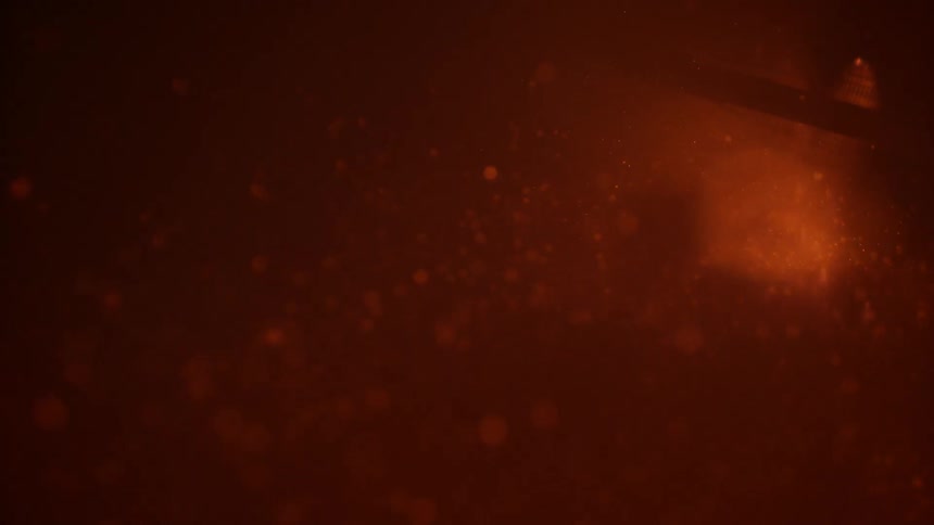 Sparks flying in a dark area with smoke