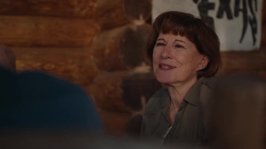 A woman nods and listens to a friend