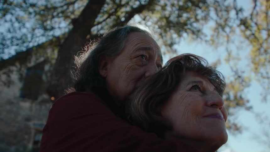 A clip of an elderly couples sharing a romantic moment