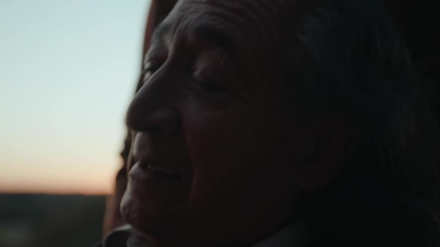 Portrait of an elderly man talking and shaking his head