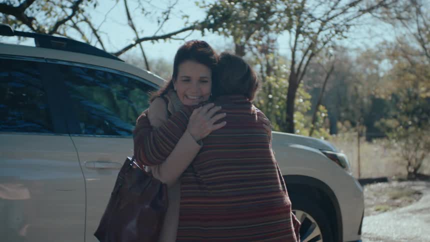 Mother and daughter greeting each other affectionately