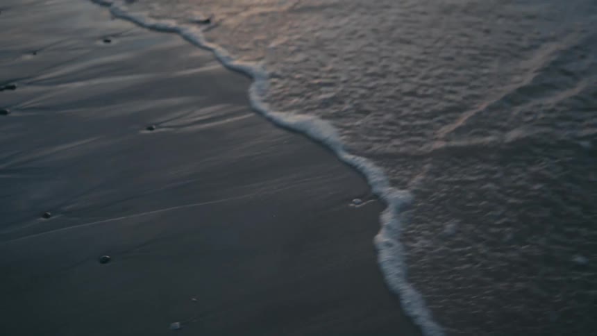 Sea water reaching the beach sand