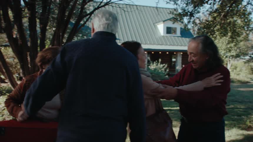 Group of people hugging and greeting each other in a happy manner