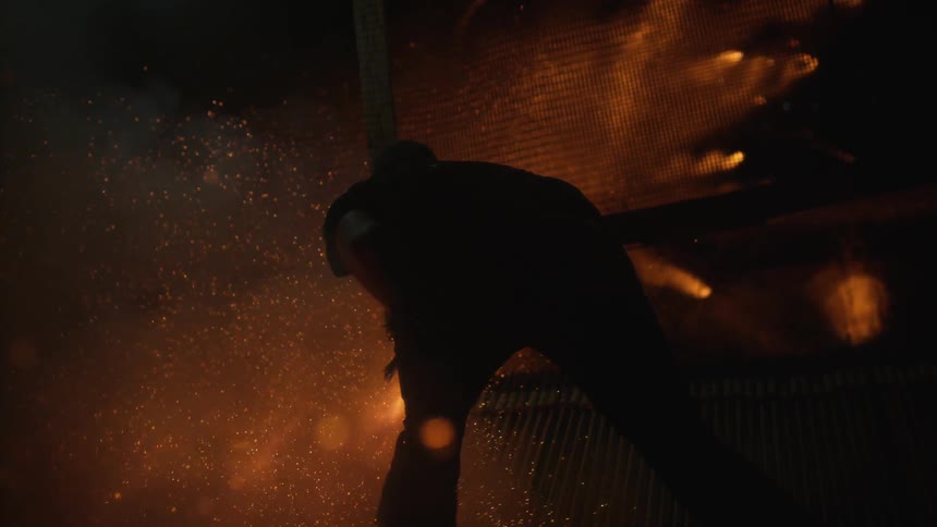 Sparks from fireworks fly around a man