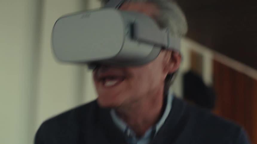 Cheerful man interacting with virtual reality glasses