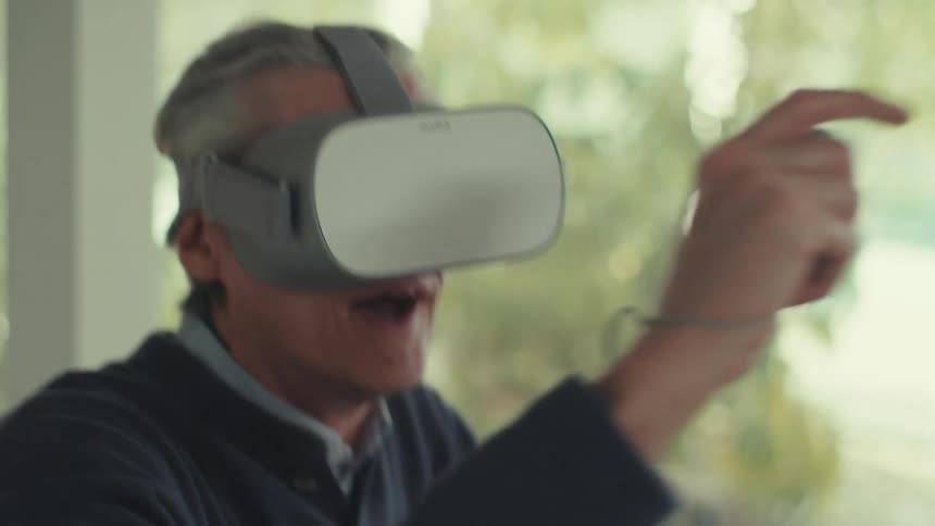 Man putting on virtual reality glasses and having fun