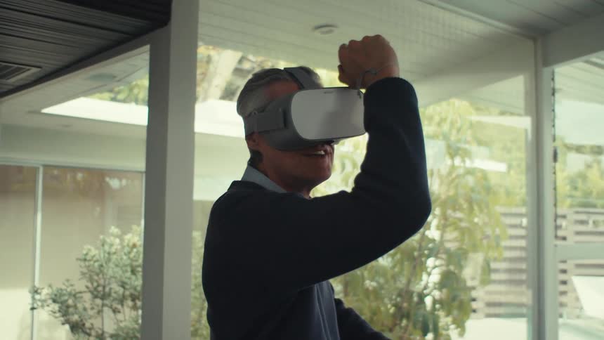 Man putting on virtual intelligence glasses and playing