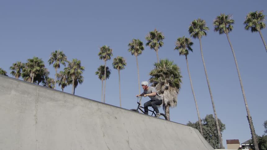 Man riding a bmx bike in a park