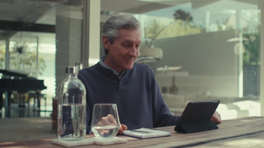A man is talking with someone on his tablet