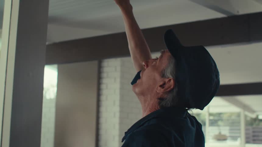 A worker is measuring in the home