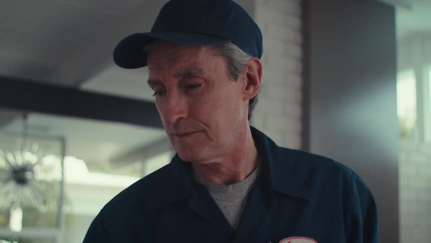 Service worker nods after verifying things while working in a house