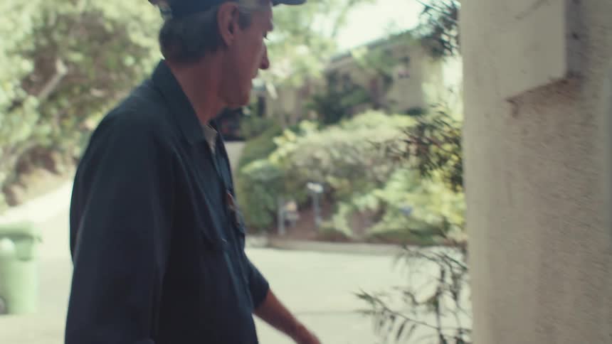 A clip of a person taking a measurement of a wall outdoor