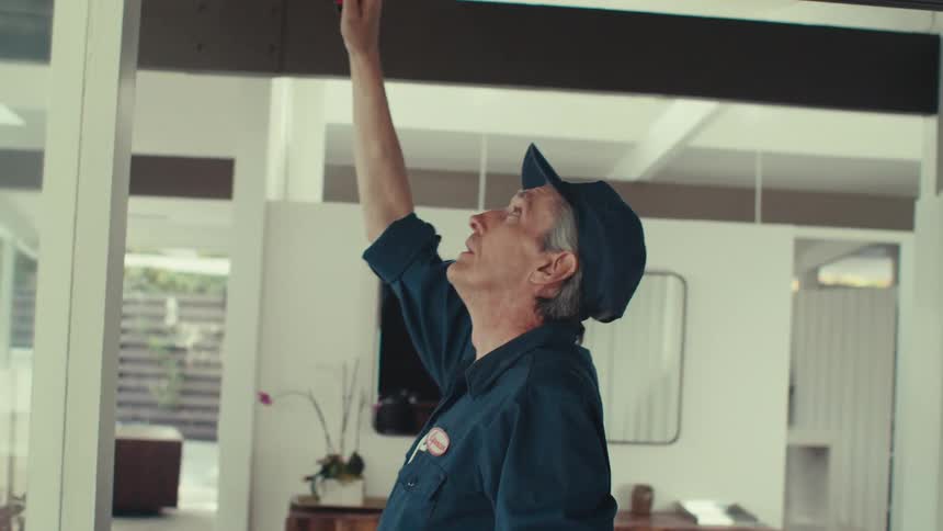 A worker is measuring the ceiling in the home