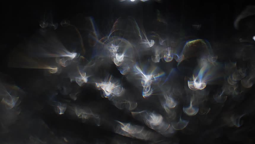 Shimmering light refractions and reflections create an abstract ethereal visual pattern