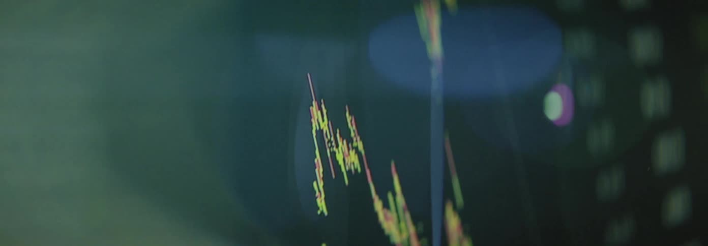 A glowing line graph showing fluctuating financial data