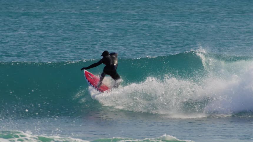 Man surfing a wave with radical maneuvers