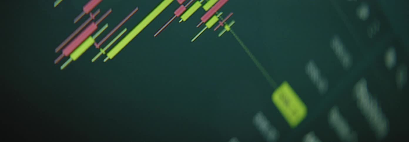 A closeup view of a stock market chart with red and green candlesticks fluctuating