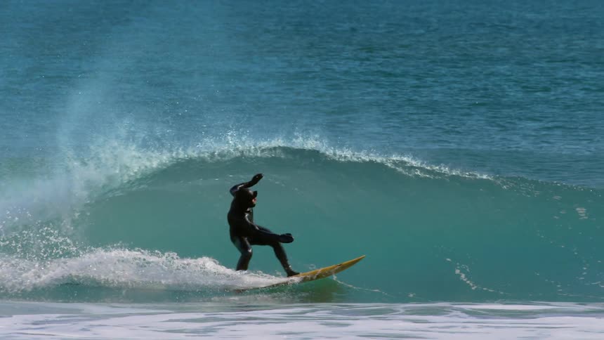 A man is surfing on a wave