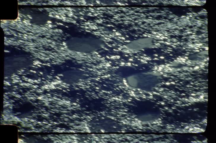 Sunlight shines onto muddy ground containing scattered puddles