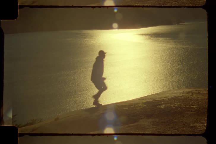A footage of a person running the hill at dawn
