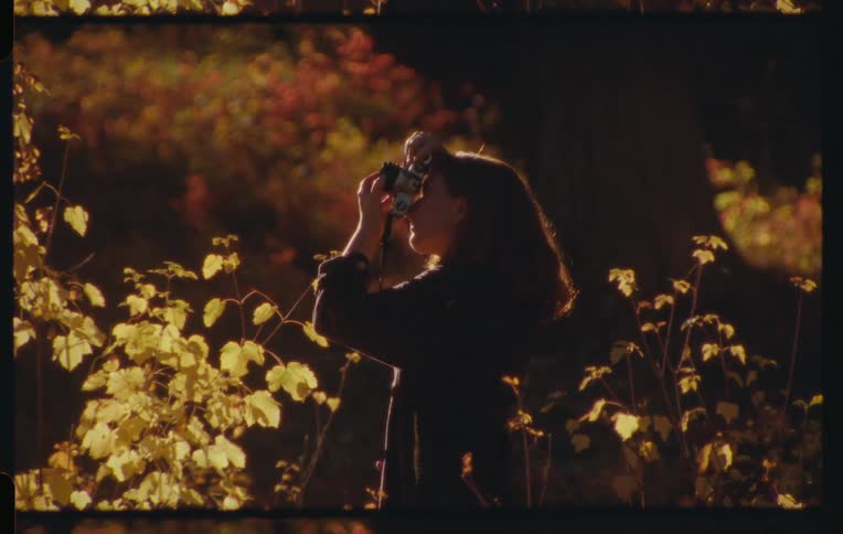 A film clip of lady taking a picture
